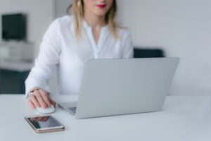 A woman using a silver laptop