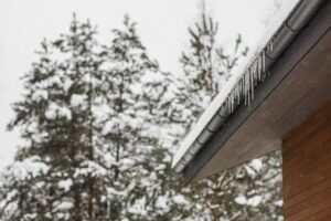 A roof with gutters covered in ice and snow.