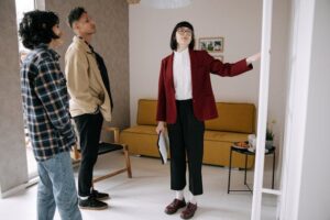 A real estate agent showing an apartment to a young couple.